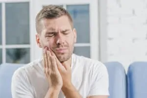 close up man suffering from toothache