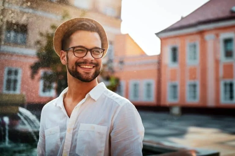 portrait of handsome young man smiling outdoors