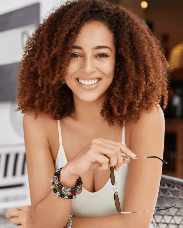 Curly hair black woman smilling