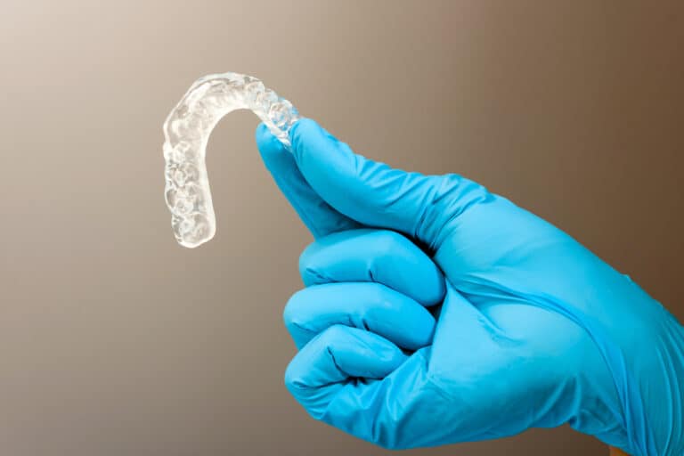 dental mouth guard holden by gloves