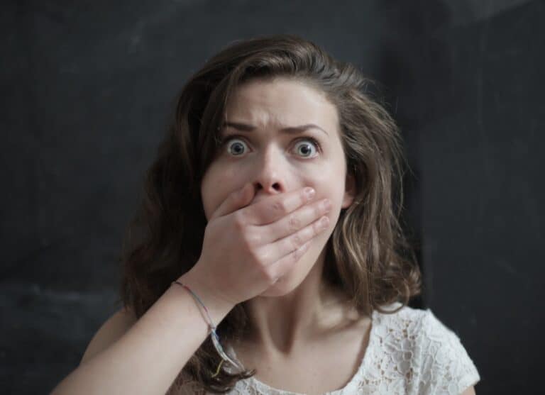 woman surprised with hand covering the mouth