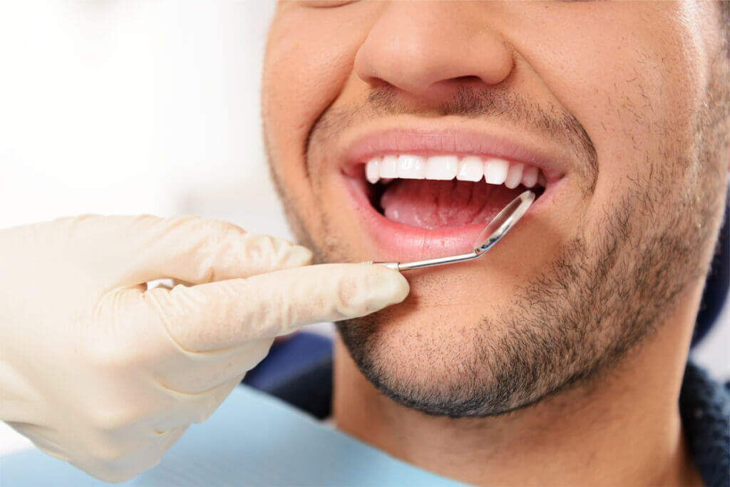 Young man with mouth open at the dentist