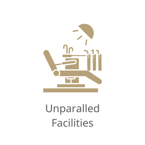 Gold Icon of a dental chair and Text: Unparalled Facilities